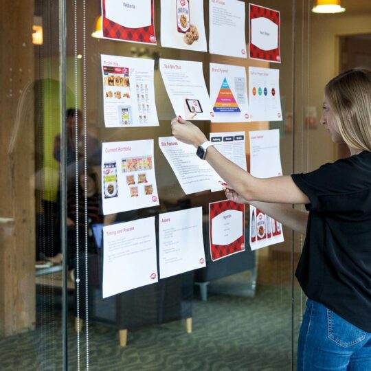 Woman looking at presentation slides on a glass wall